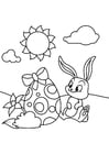 Dibujos para colorear Conejito de pascua con huevo de pascua en el jardín