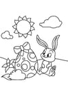 Dibujo para colorear Conejito de pascua con huevo de pascua en el jardÃ­n